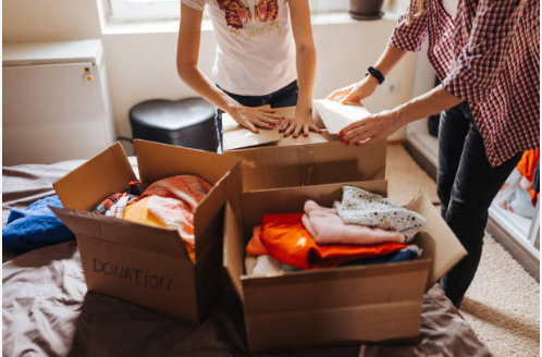 Helping hands packing up goods to donate to those less fortunate.